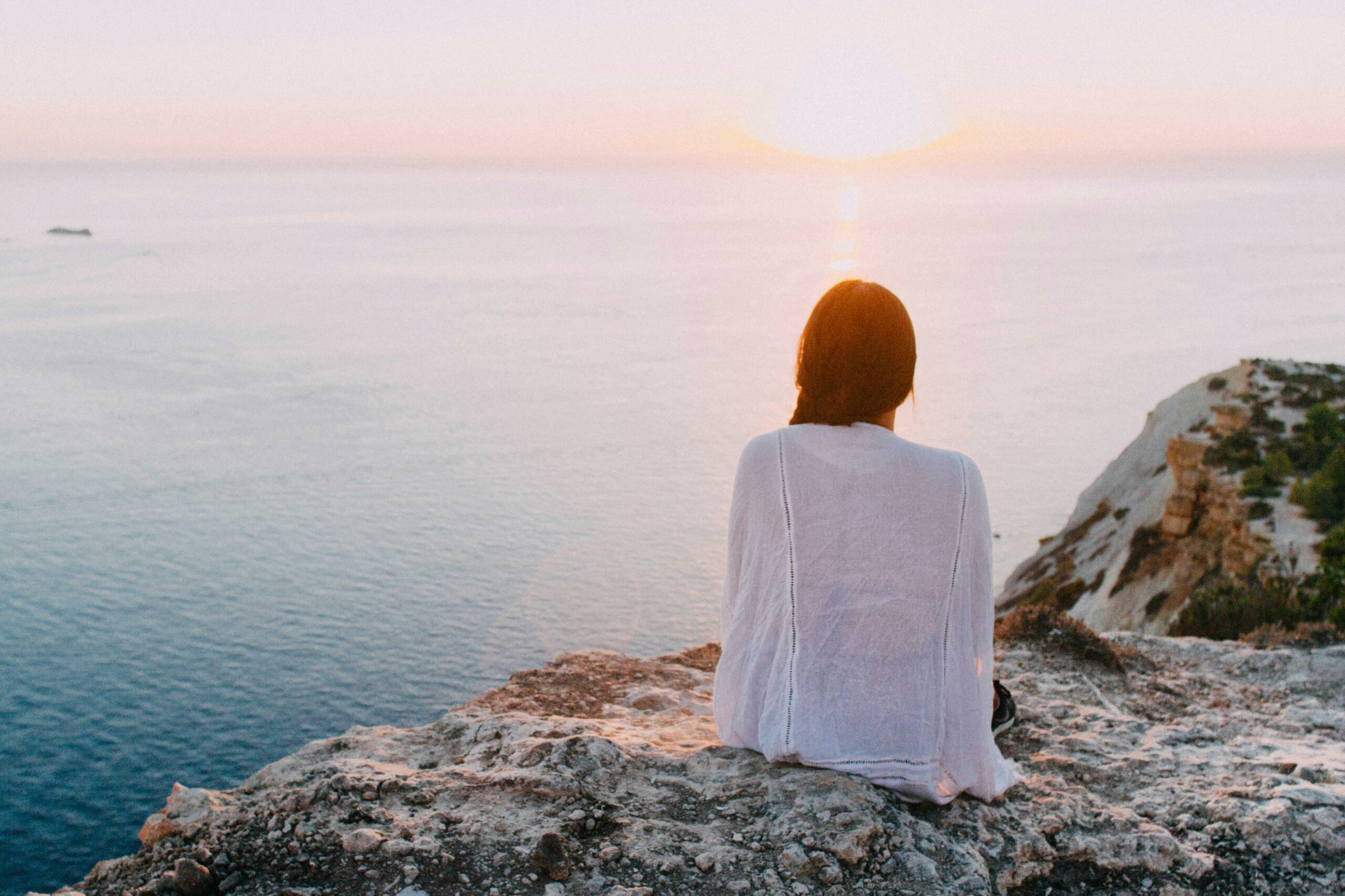 Photo by Riccardo: https://www.pexels.com/photo/woman-sitting-on-gray-rock-near-body-of-water-185801/